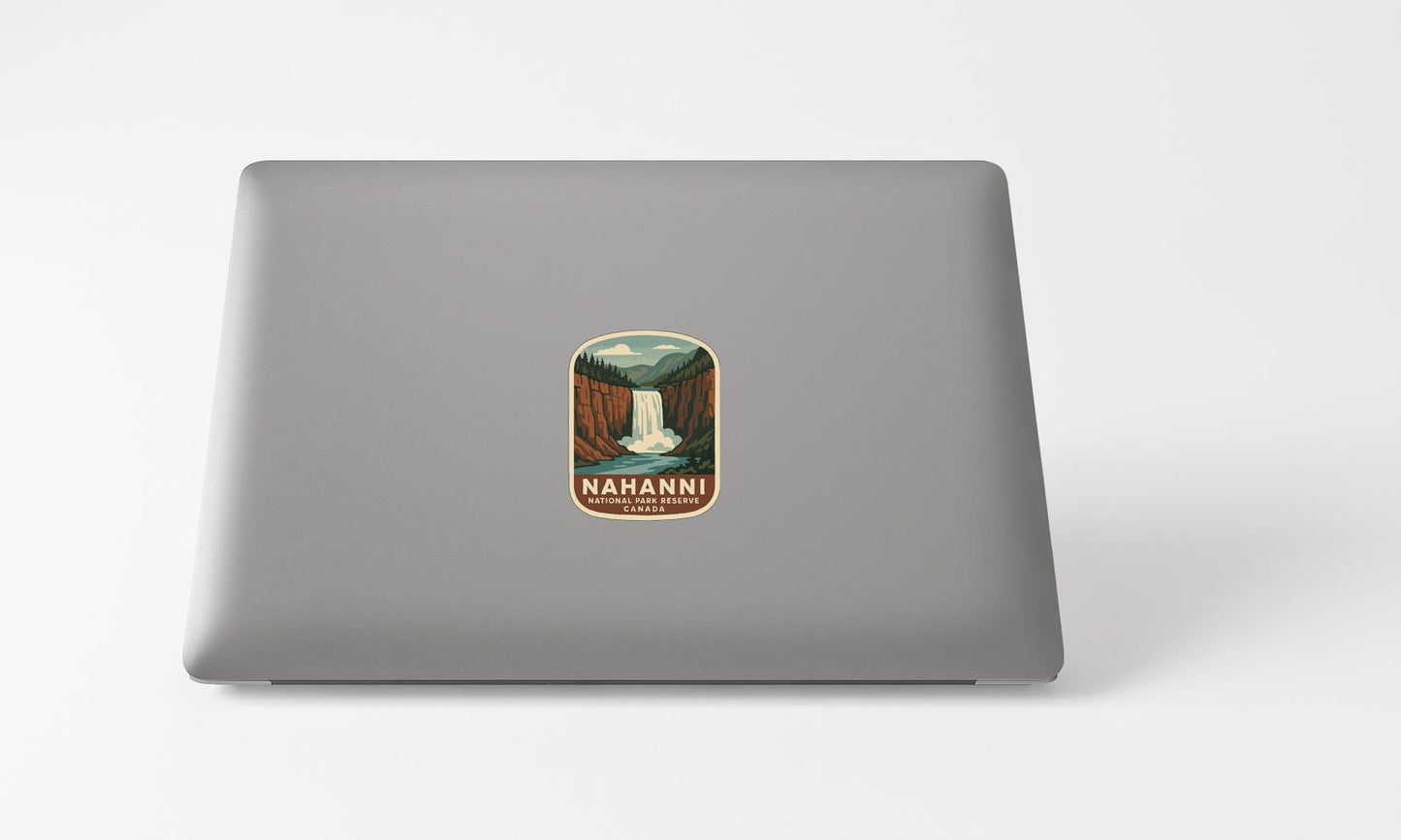 A sticker with a waterfall and mountains on a laptop.