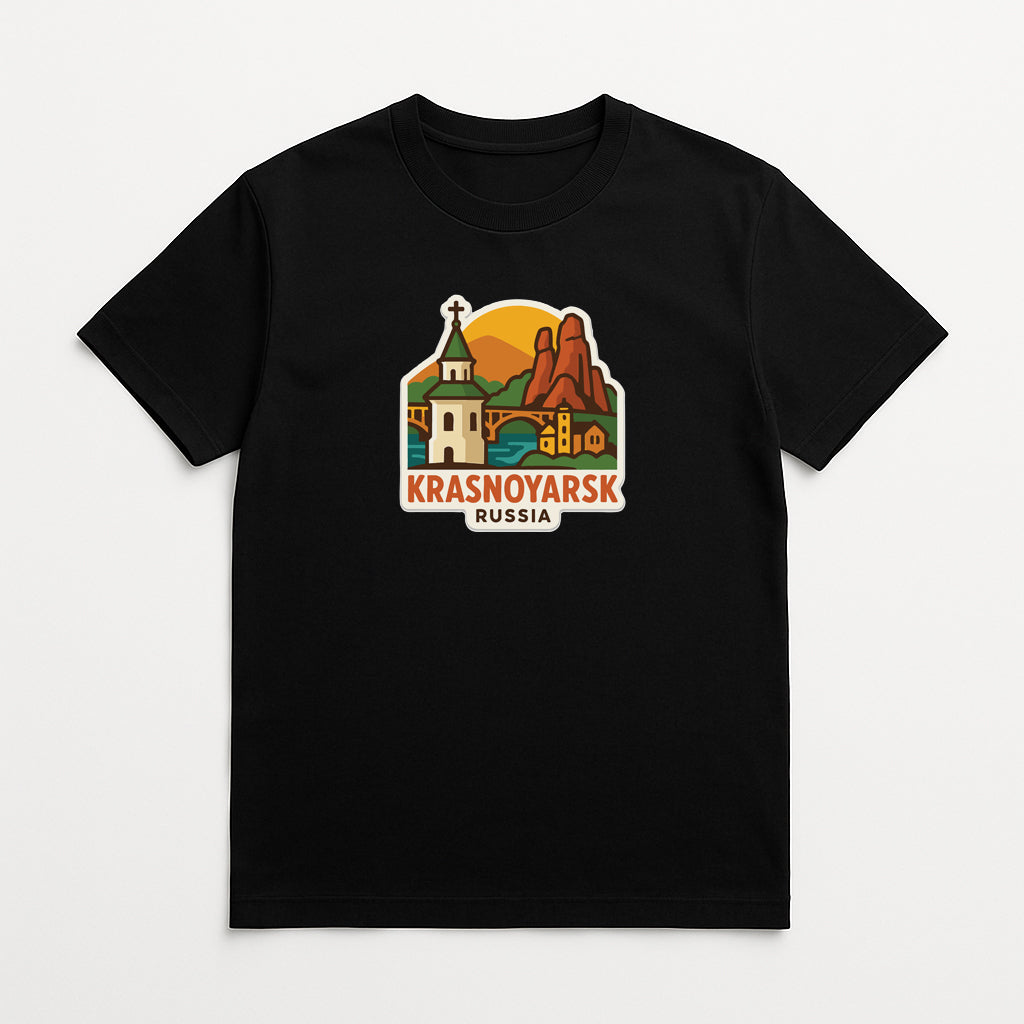 A black t-shirt with a graphic design depicting a scenic landscape with mountains, buildings, and a church. The text "Krasnoyarsk Russia" is displayed below the image.