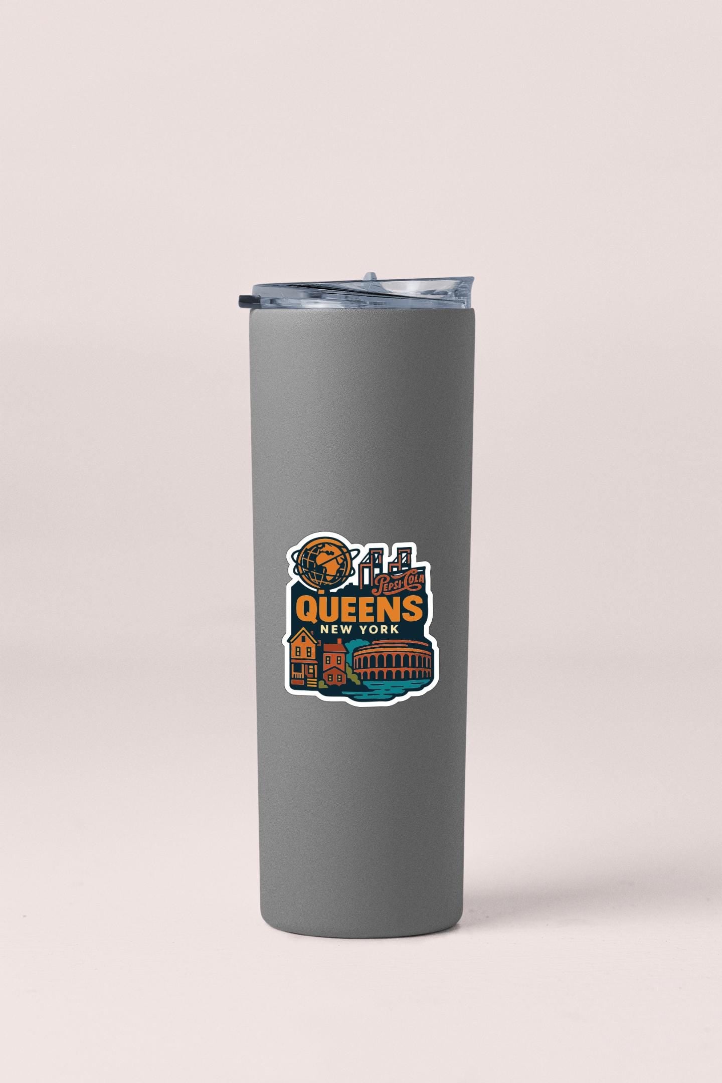 A gray insulated tumbler with a sticker depicting the city of Queens, New York.