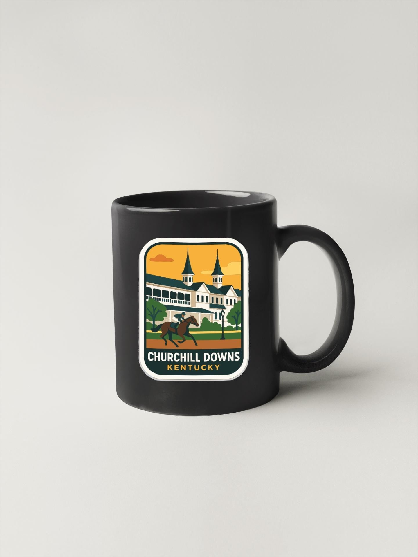 A black coffee mug with a graphic design depicting a horse and jockey racing around a Kentucky racetrack.