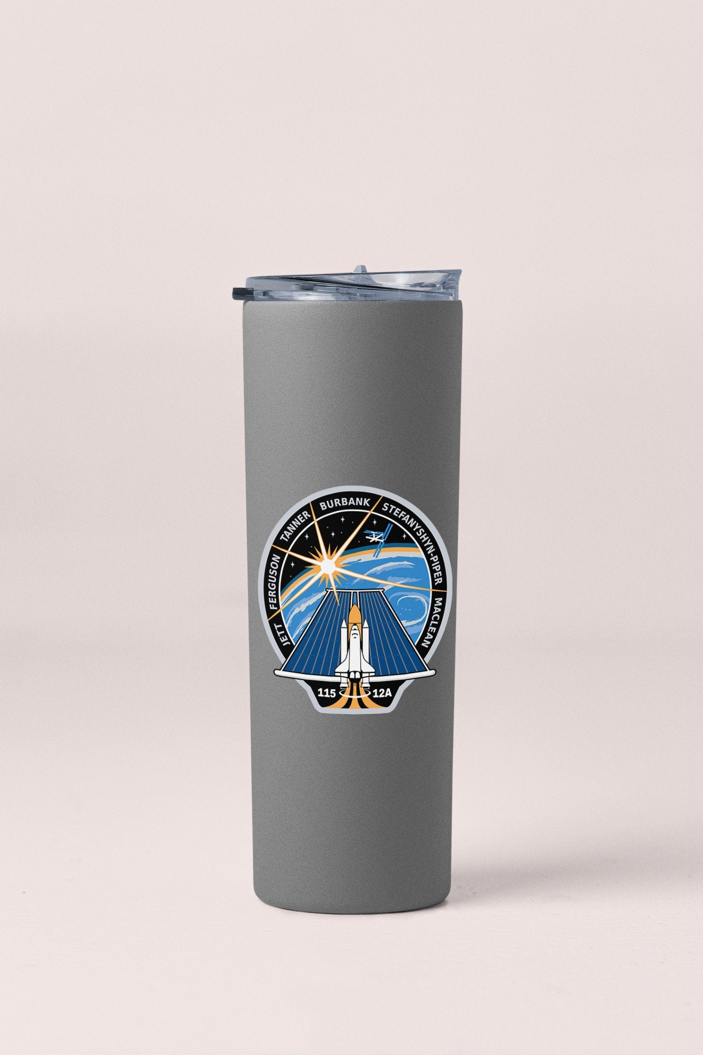 a travel mug with a picture of a lighthouse on it