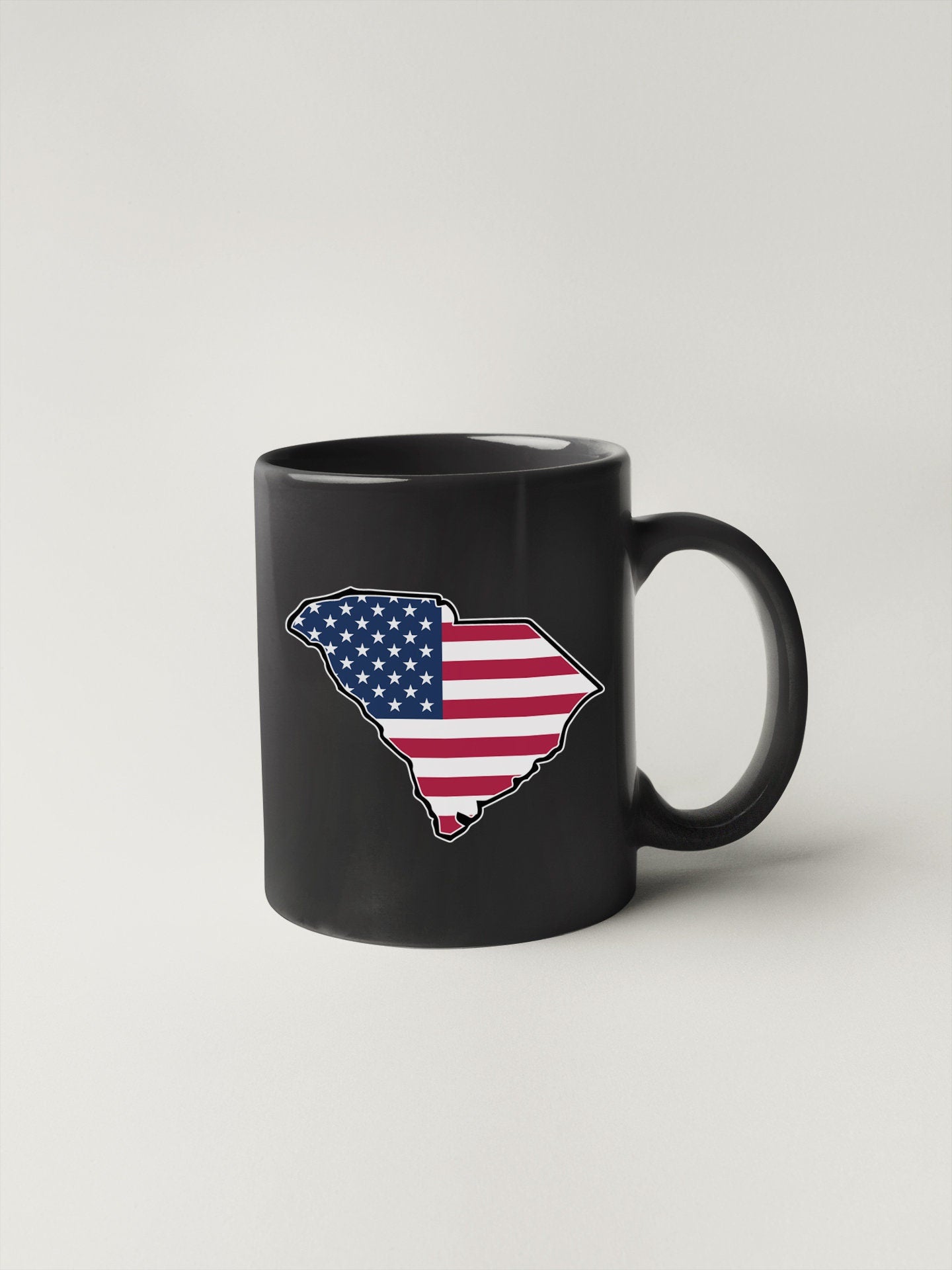 a black coffee mug with the state of texas painted on it