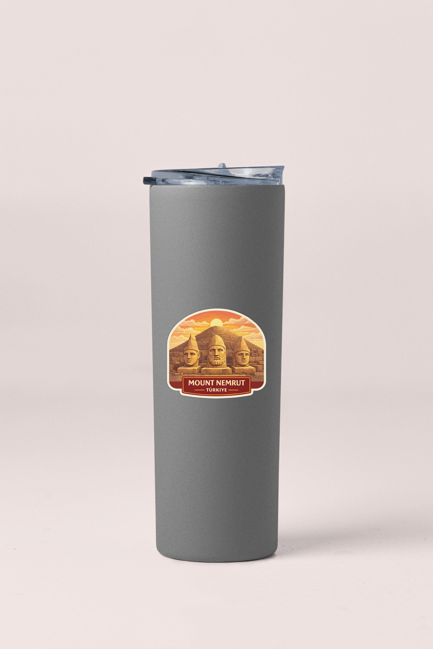 A gray cylindrical container with a lid and a label featuring the Mount Nebrut monument in Istanbul, Turkey.