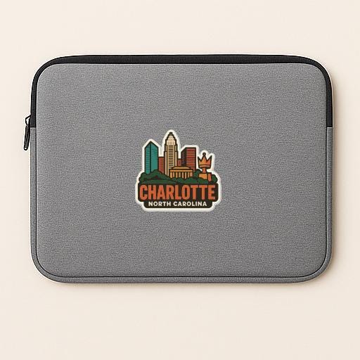 A gray laptop sleeve with a cityscape sticker on it, featuring the text "CHARLOTTE NORTH CAROLINA".