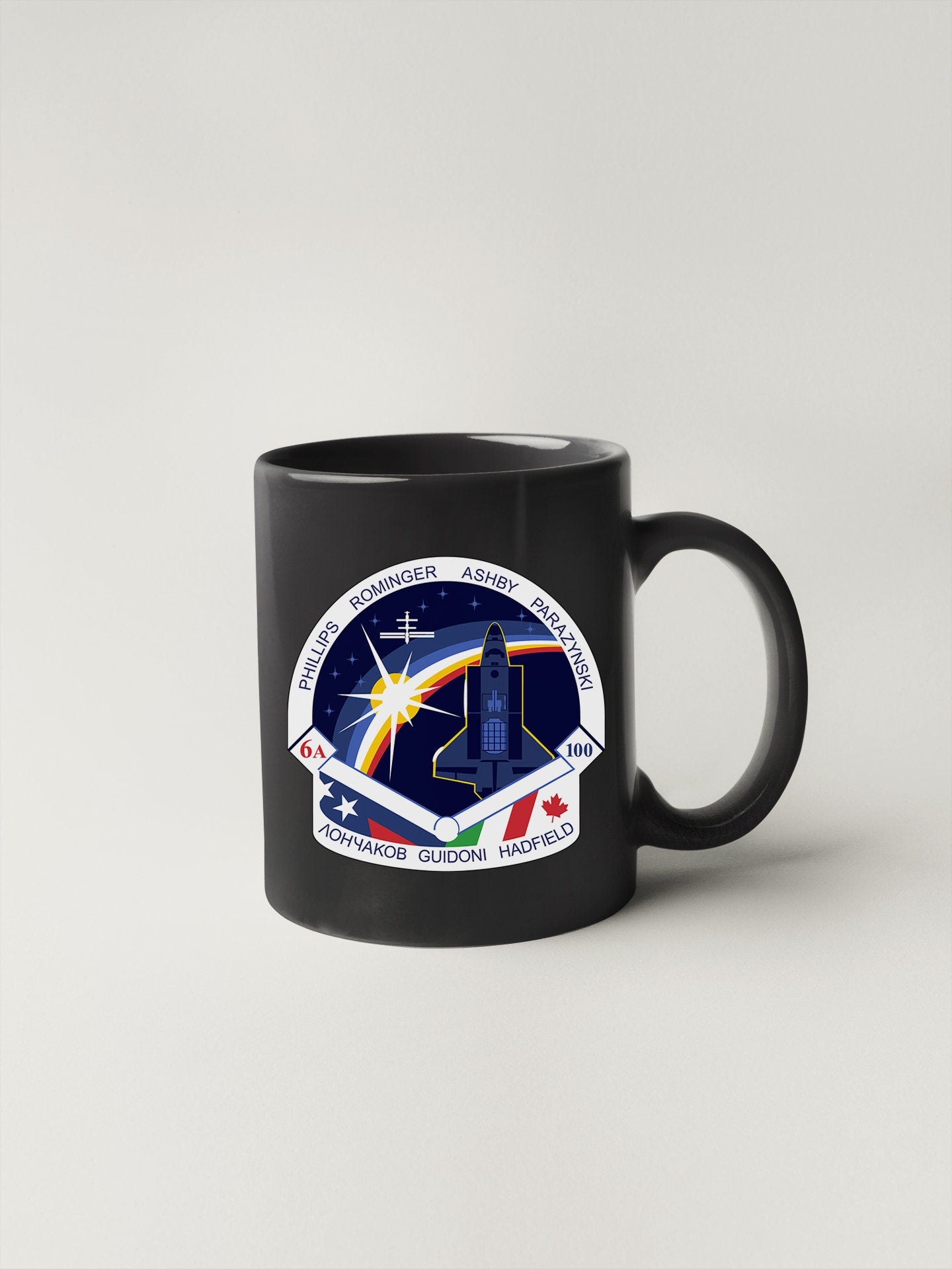a black mug with a nasa emblem on it