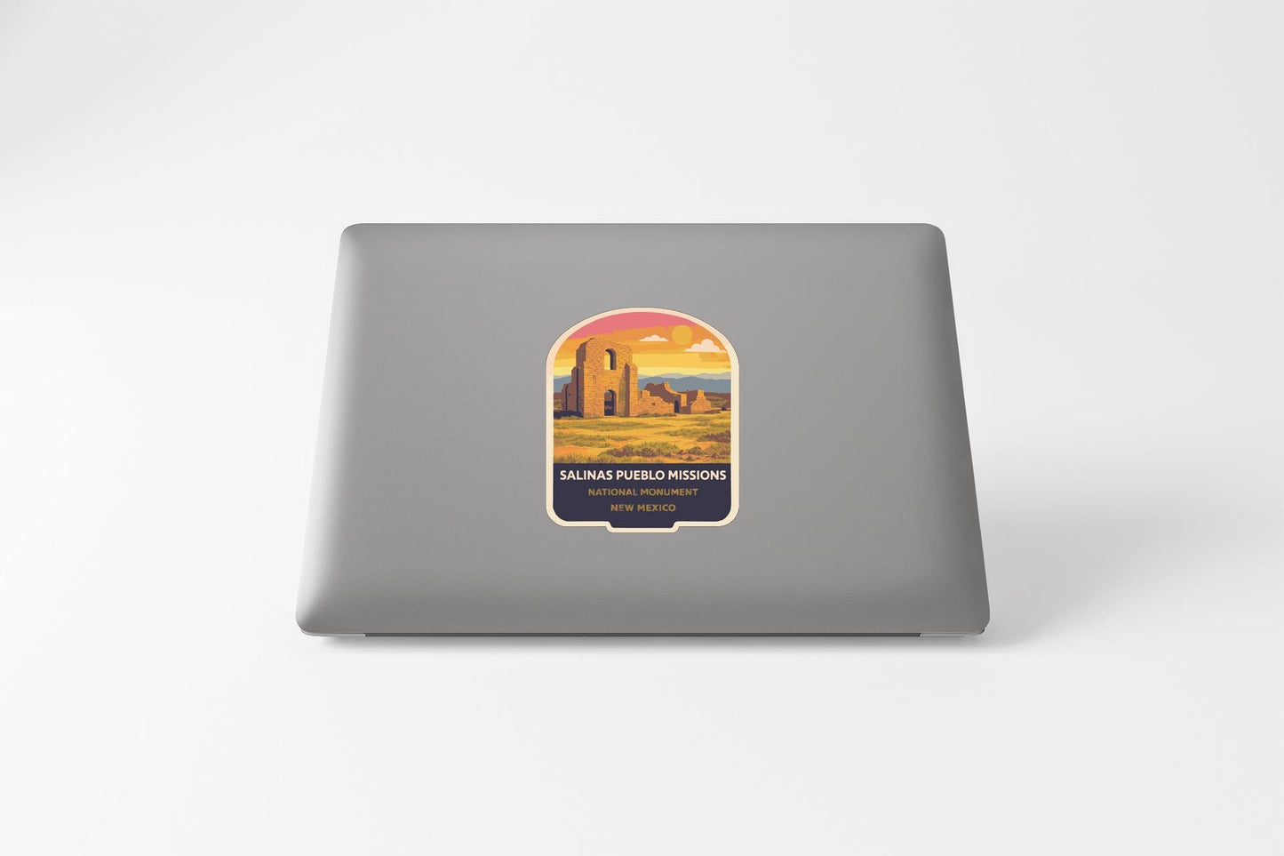a sticker with a desert landscape and a building, likely representing a location or destination.