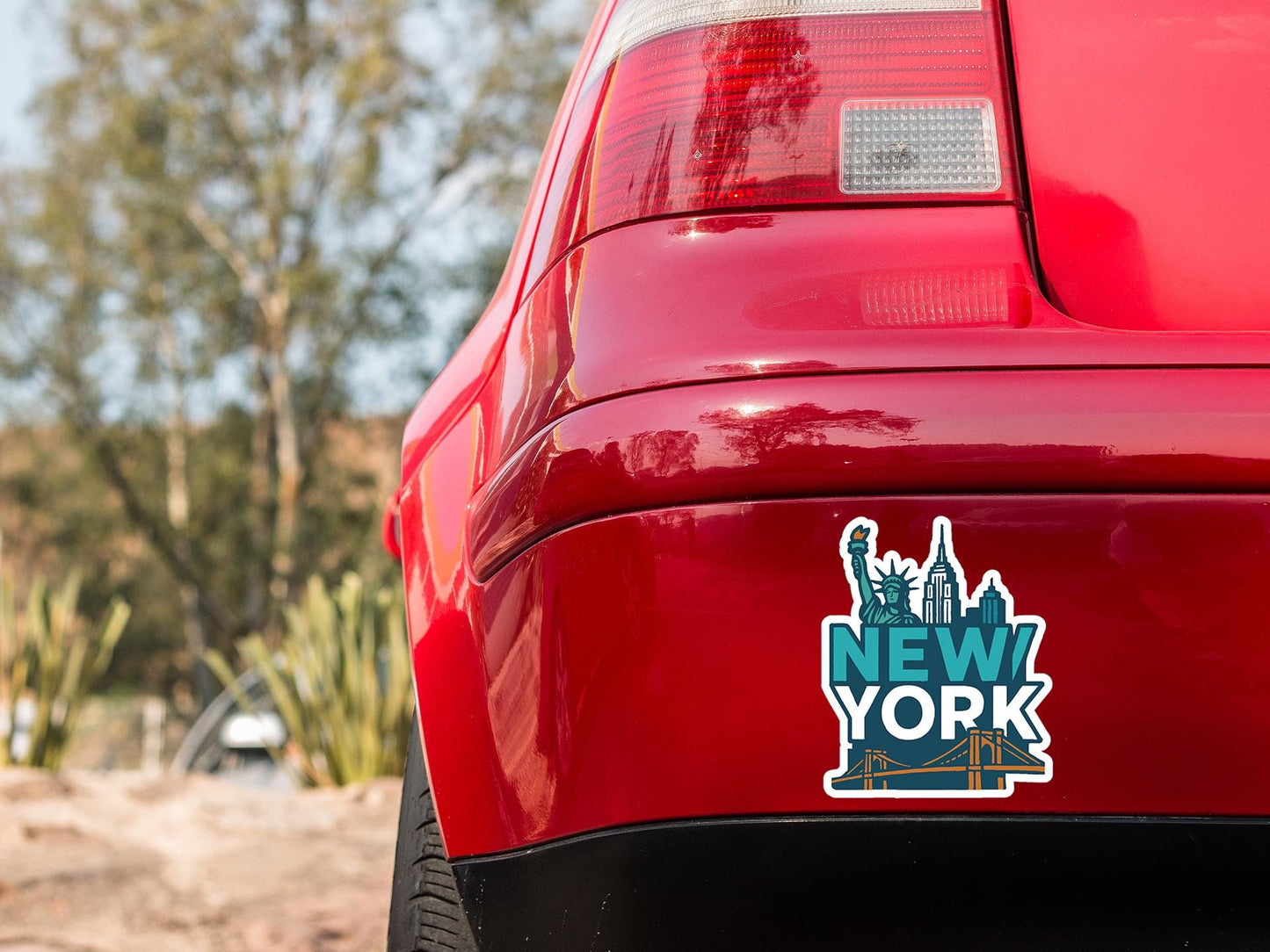 a red car with a new york sticker on it