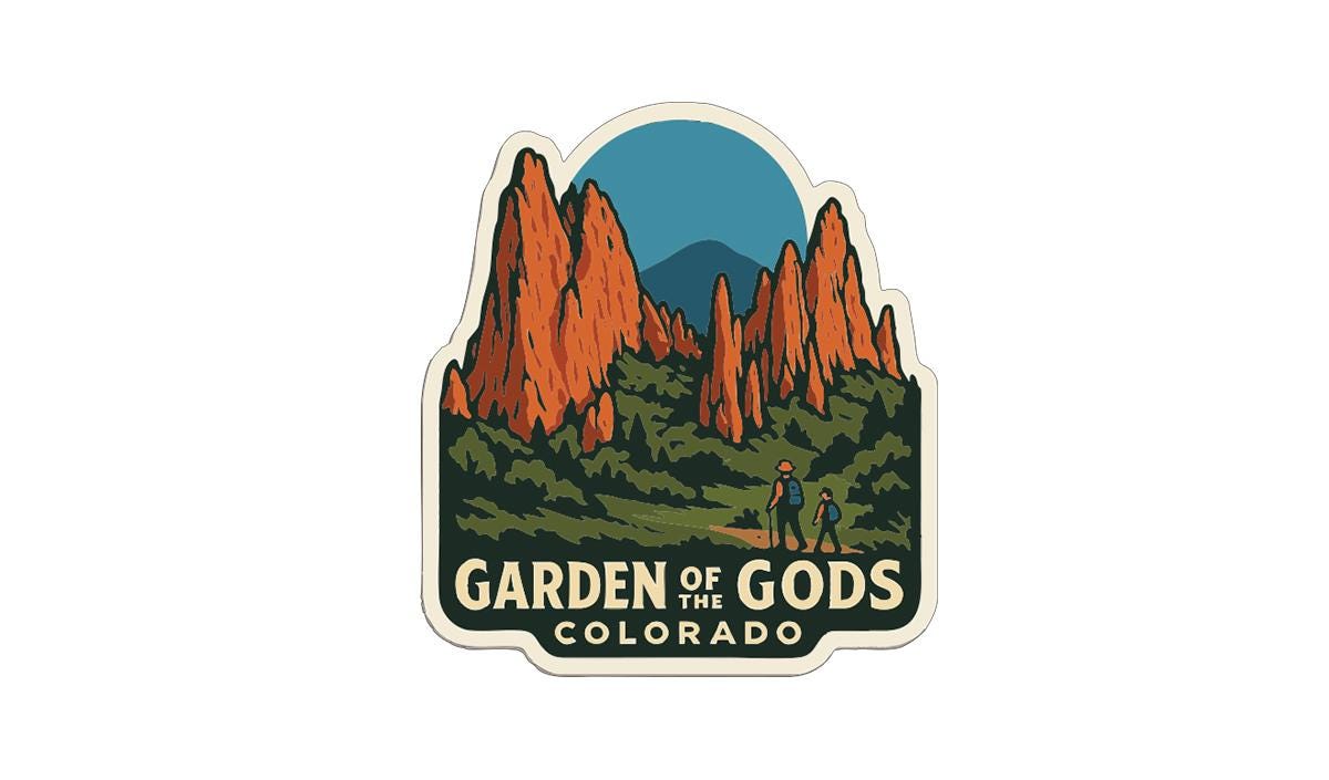 A sticker or emblem featuring a scenic landscape with mountains and a path, with the text "Garden of Gods, Colorado" prominently displayed.