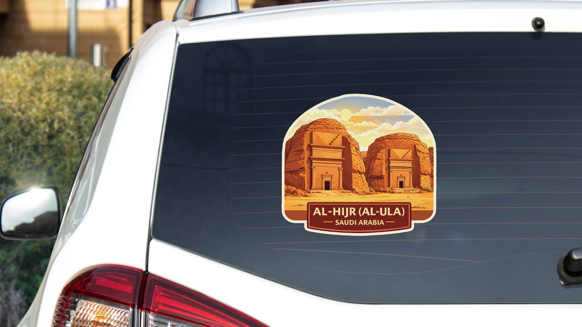 a sticker on the rear window of a car, depicting two sandstone structures, likely the Al-Hijr (Al-Ula) and Saudi Arabia.