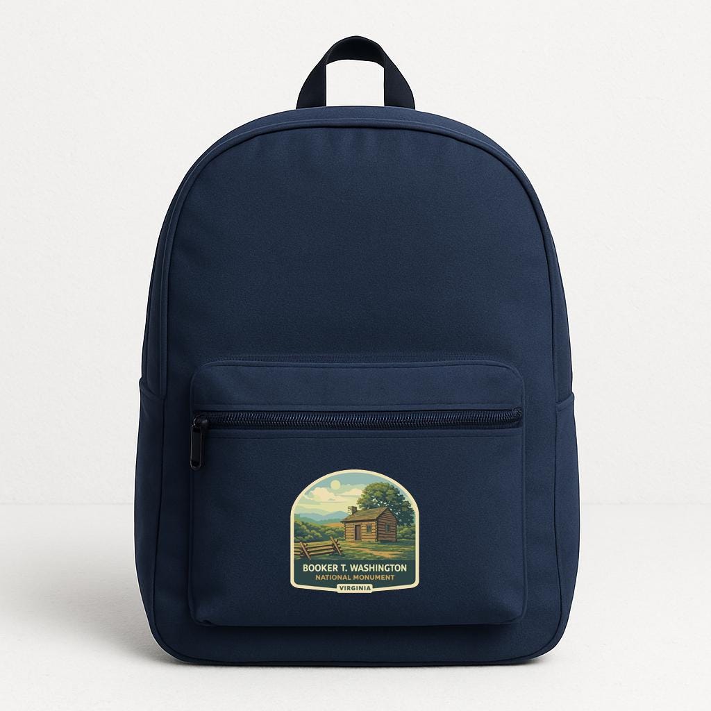 A navy blue backpack with a sticker on the front that says "BOOKER T. WASHINGTON NATIONAL PARK VIRGINIA".