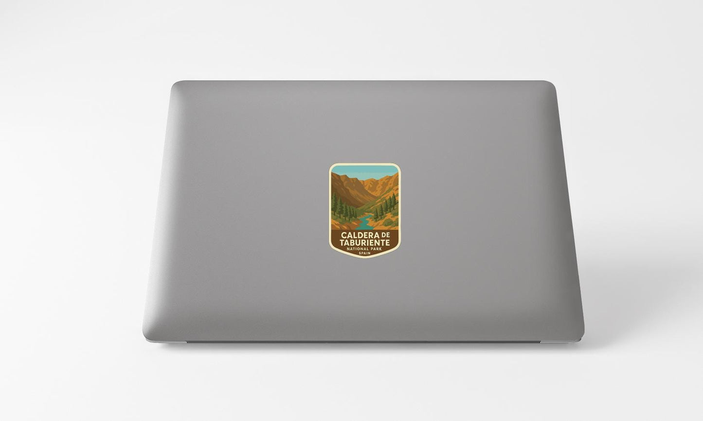 A sticker on the back of a laptop displaying a scenic mountain landscape.