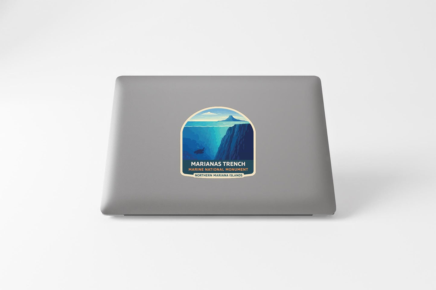 a sticker on a laptop with a mountain landscape and a blue sky.