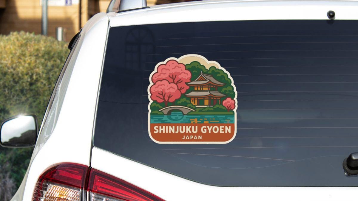 A sticker on the rear window of a car depicting a scenic view of Shinjuku Gyoen, Japan.