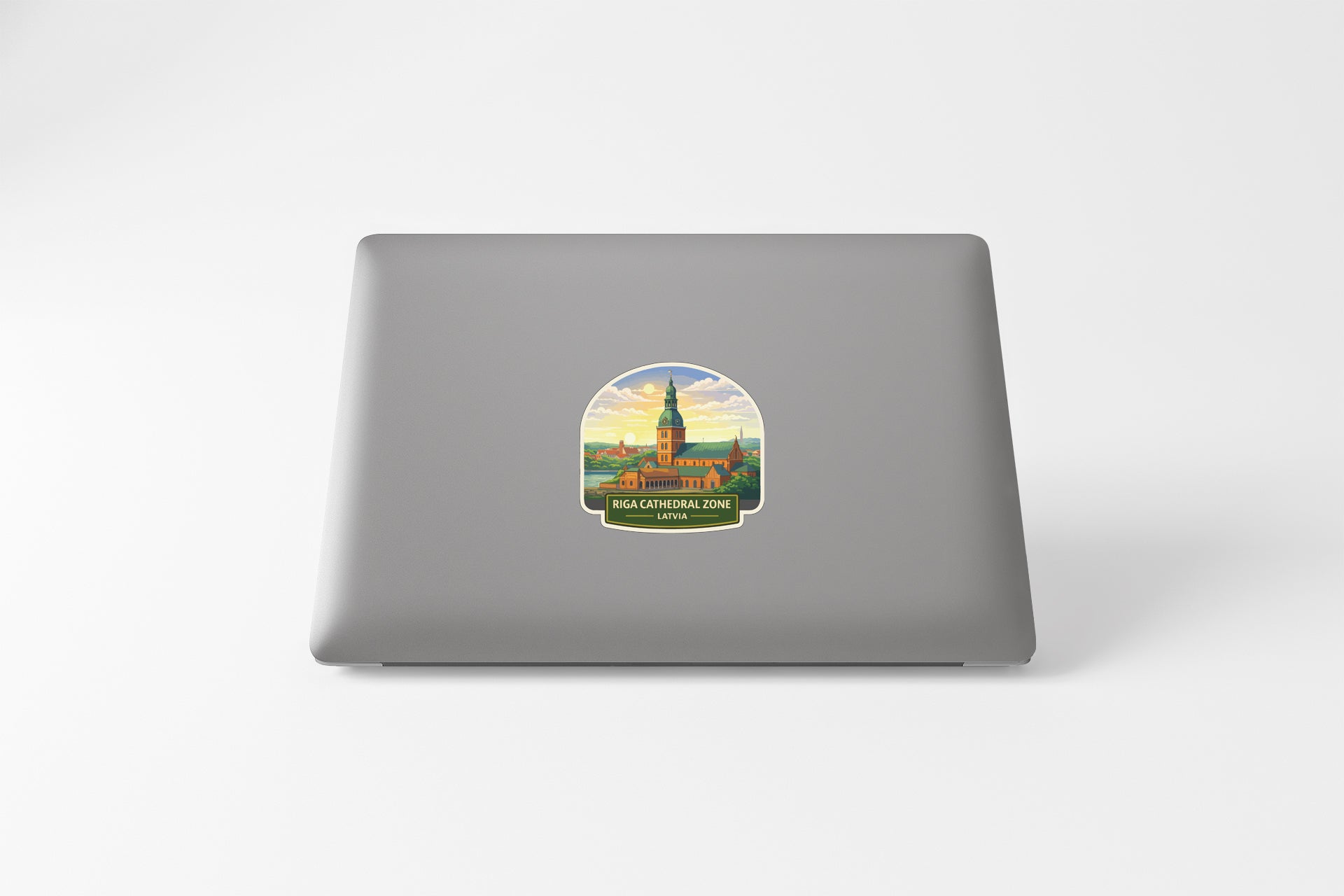 A sticker depicting a building with a tower on a laptop.