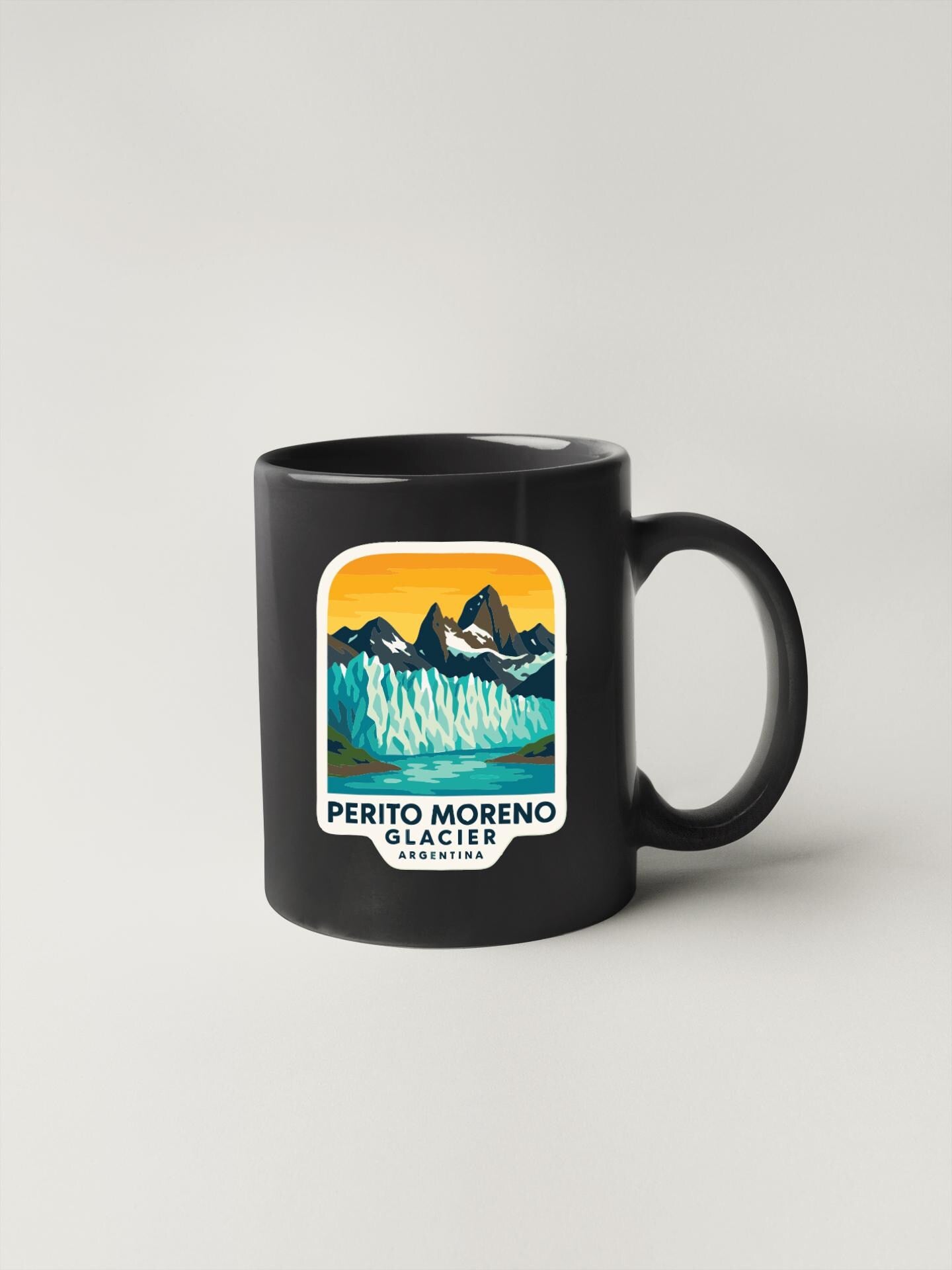 A black coffee mug with a graphic design depicting Perito Moreno Glacier in Argentina.