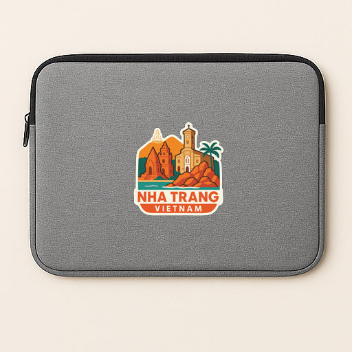 a gray laptop sleeve with a sticker depicting a cityscape and the text "NHA TRANG VIE" (Nha Trang, Vietnam).