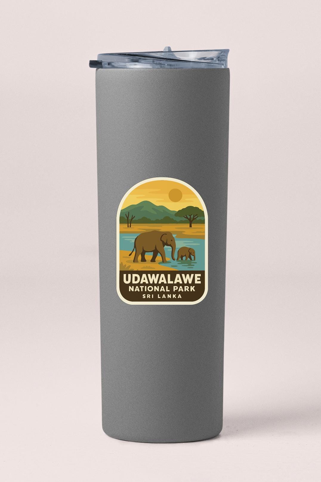 A gray cylindrical container with a label that features an illustration of elephants in a natural setting, along with the text "UDAWALAWE NATIONAL PARK Sri Lanka".