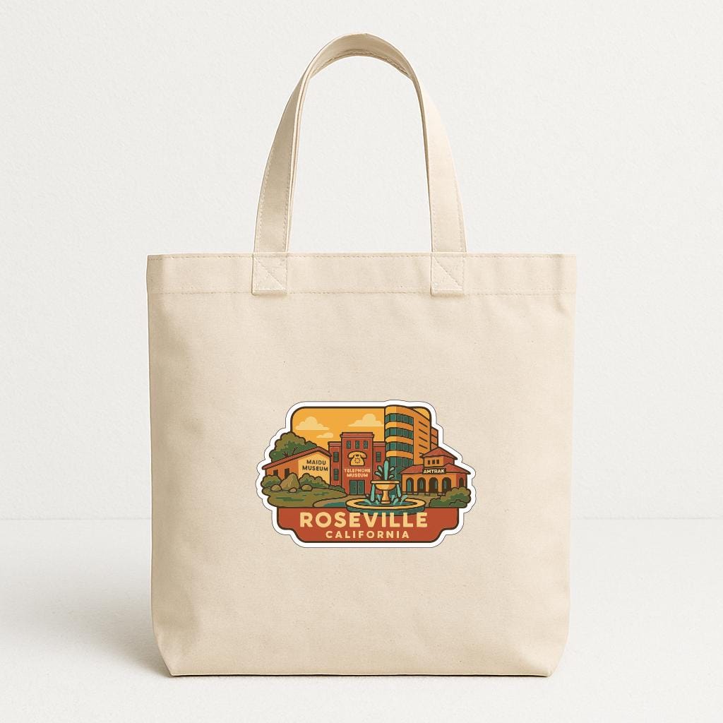 A beige tote bag with a printed design depicting a cityscape and the text "ROSEVILLE CALIFORNIA".