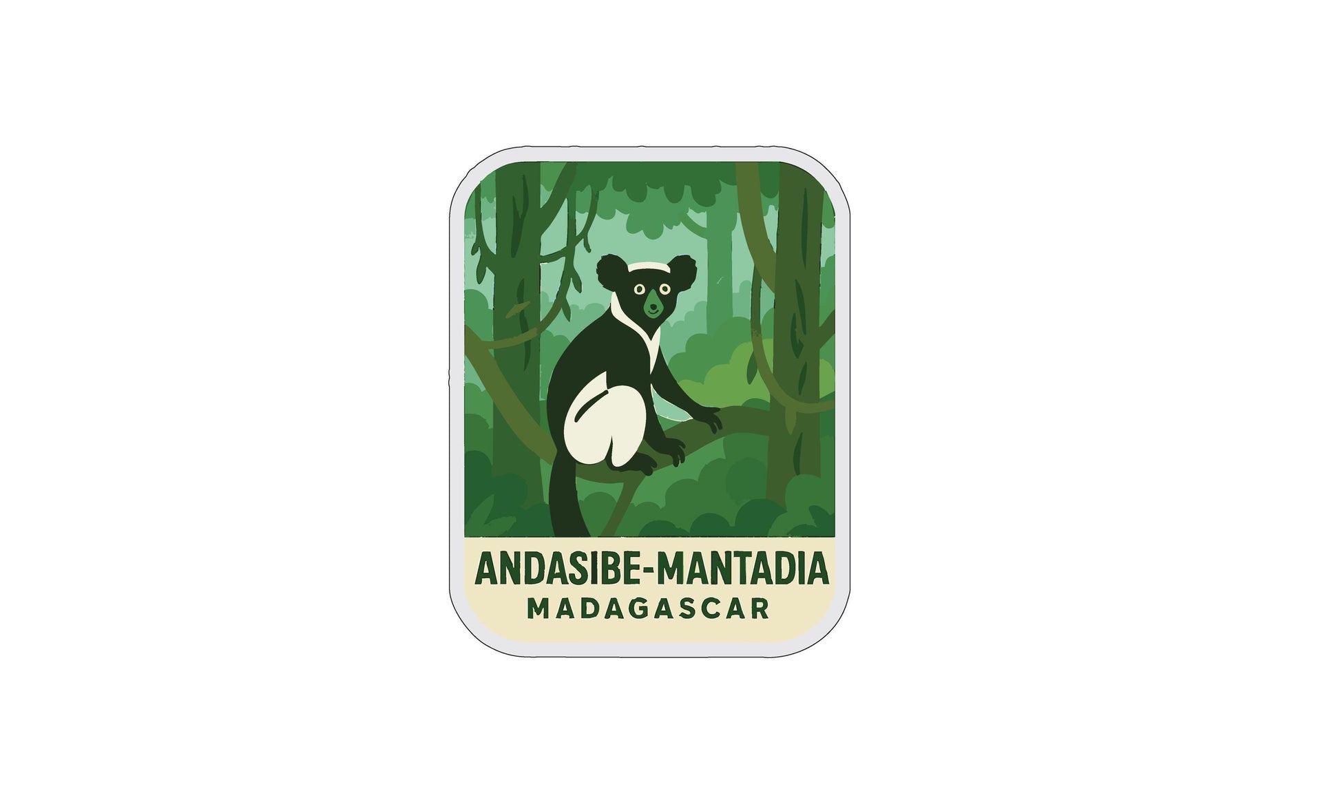 A sticker or label featuring a cartoon illustration of a lemur or similar primate in a forest setting, with the text "Andasibe-Mantadia Madagascar" below it.