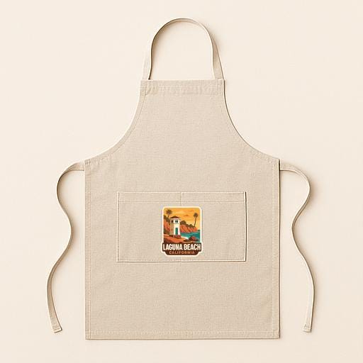 A beige apricot with a small graphic of a lighthouse and the text "Laguna Beach" printed on it.