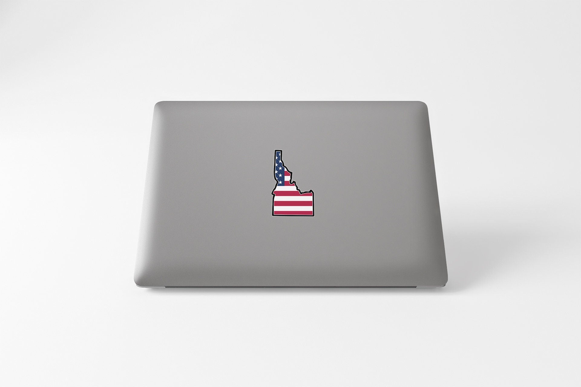a laptop with a sticker of a flag on it
