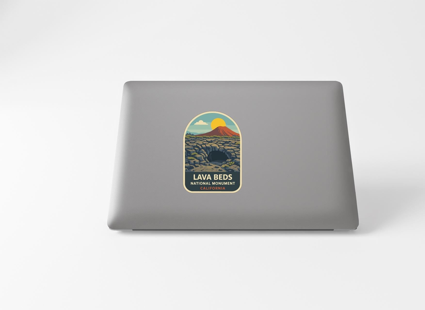 a sticker with a mountain landscape and a volcano, along with the text "LAVA BEDS NATURE DESTINATION CALIFORNIA".