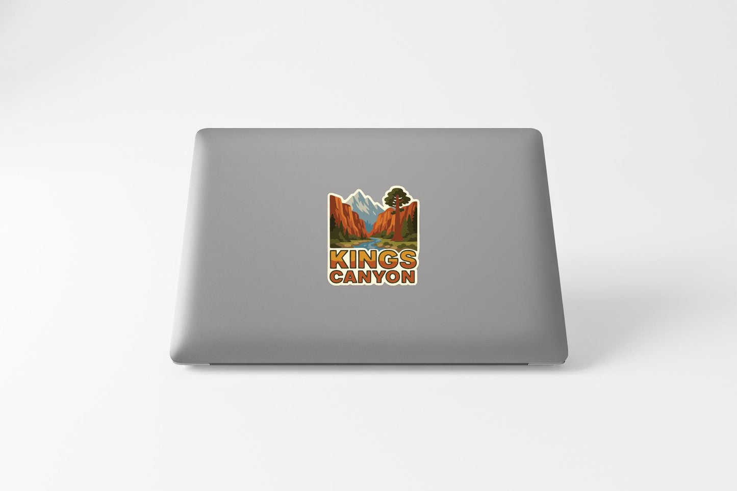 A sticker on the back of a laptop that says "KINGS CANYON".