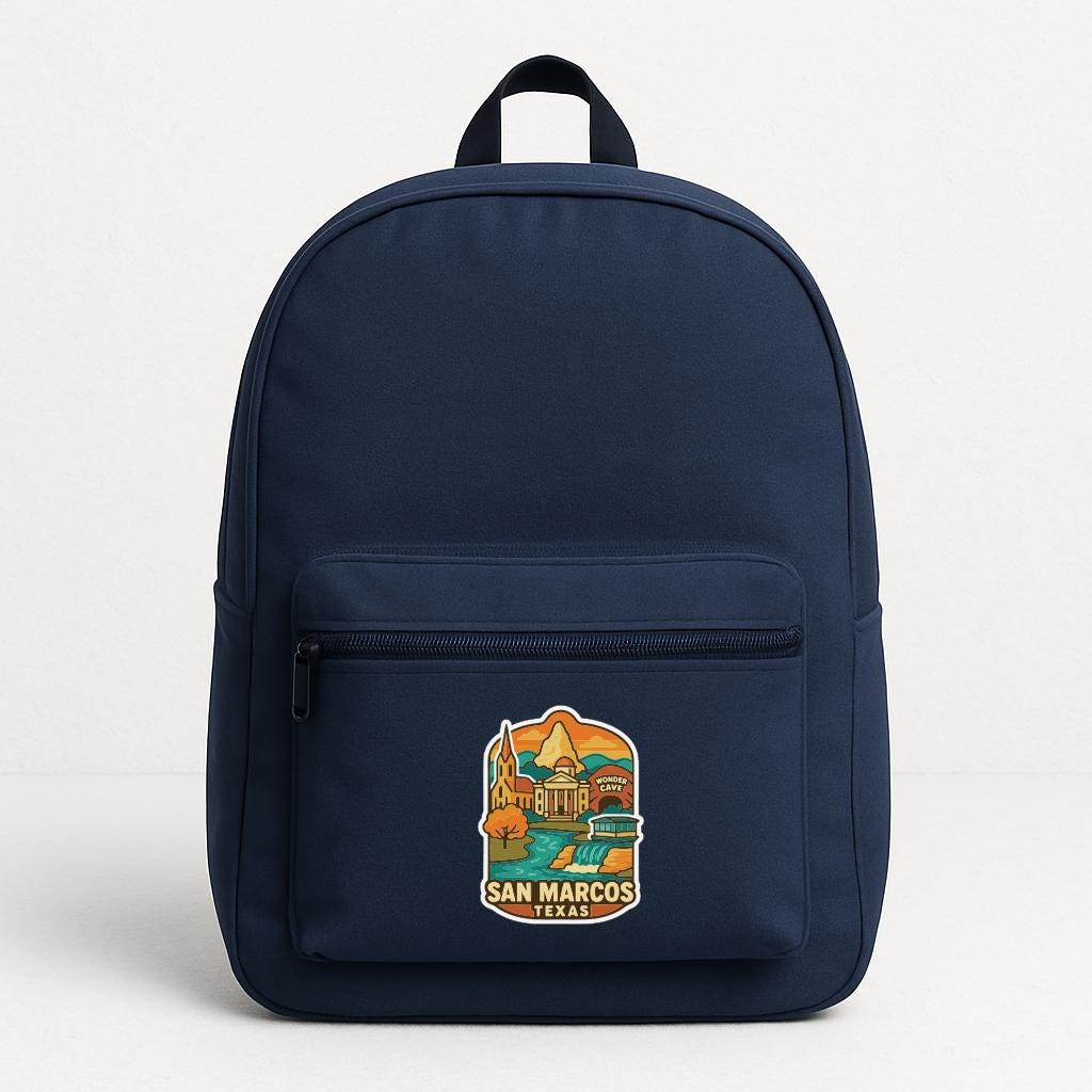 A navy blue backpack with a colorful sticker on the front, depicting a scenic view of San Marcos, California.