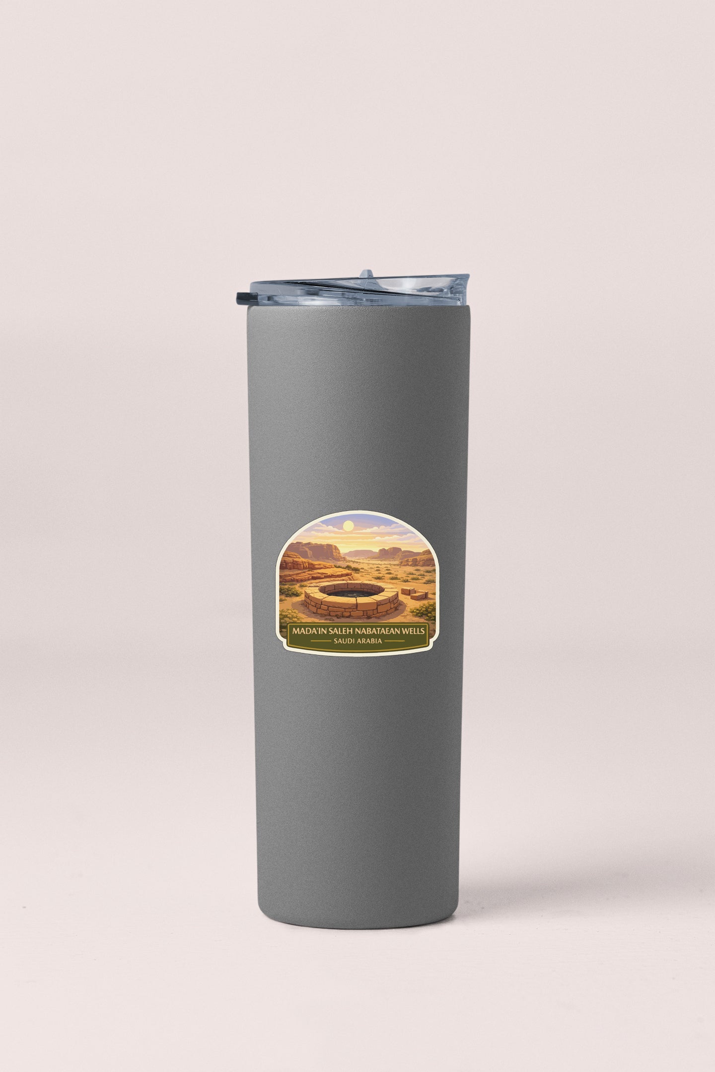 A gray insulated tumbler with a label depicting a desert landscape.