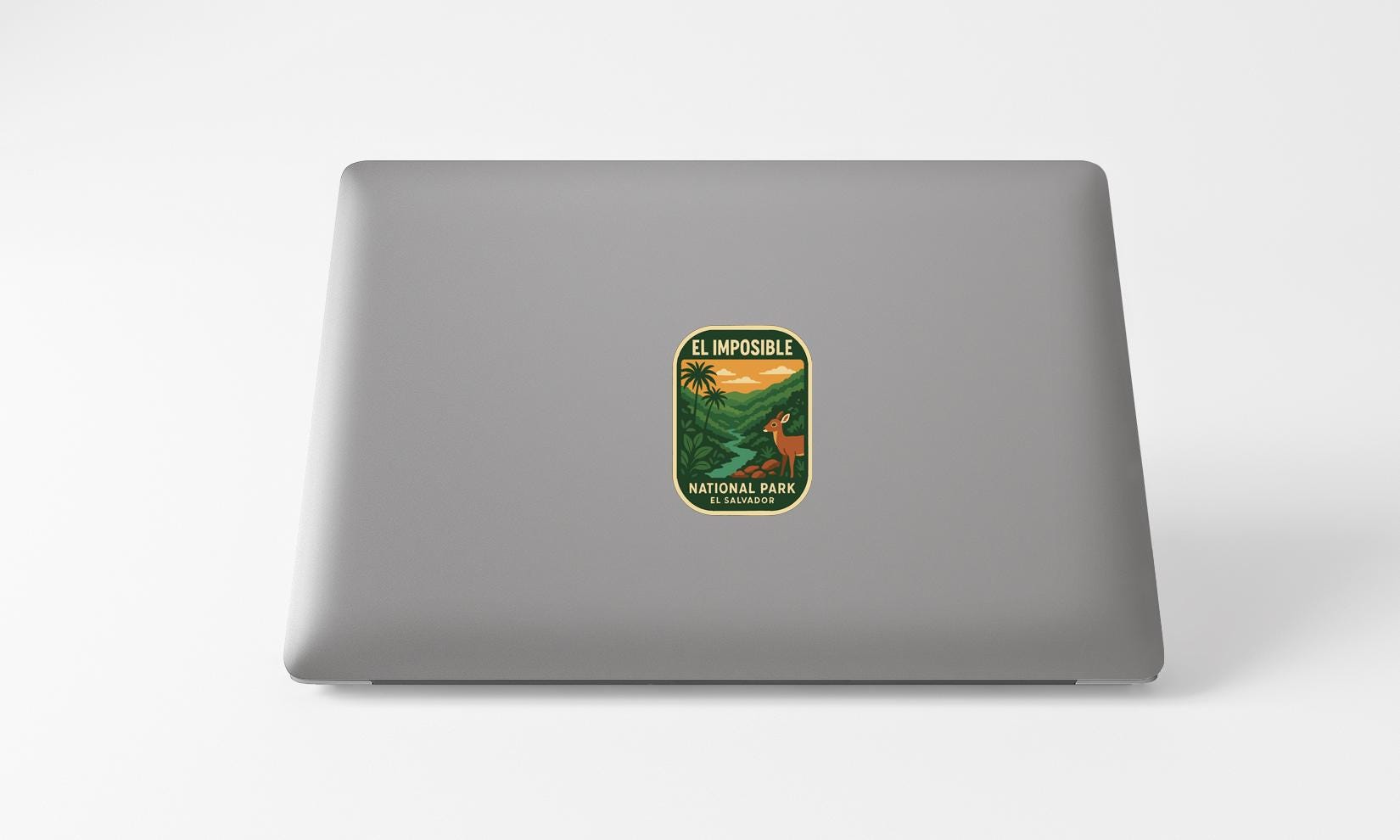 A sticker with the text "EL IMPOSIBLE NATIONAL PARK EL SALVADOR" printed on a grey laptop.