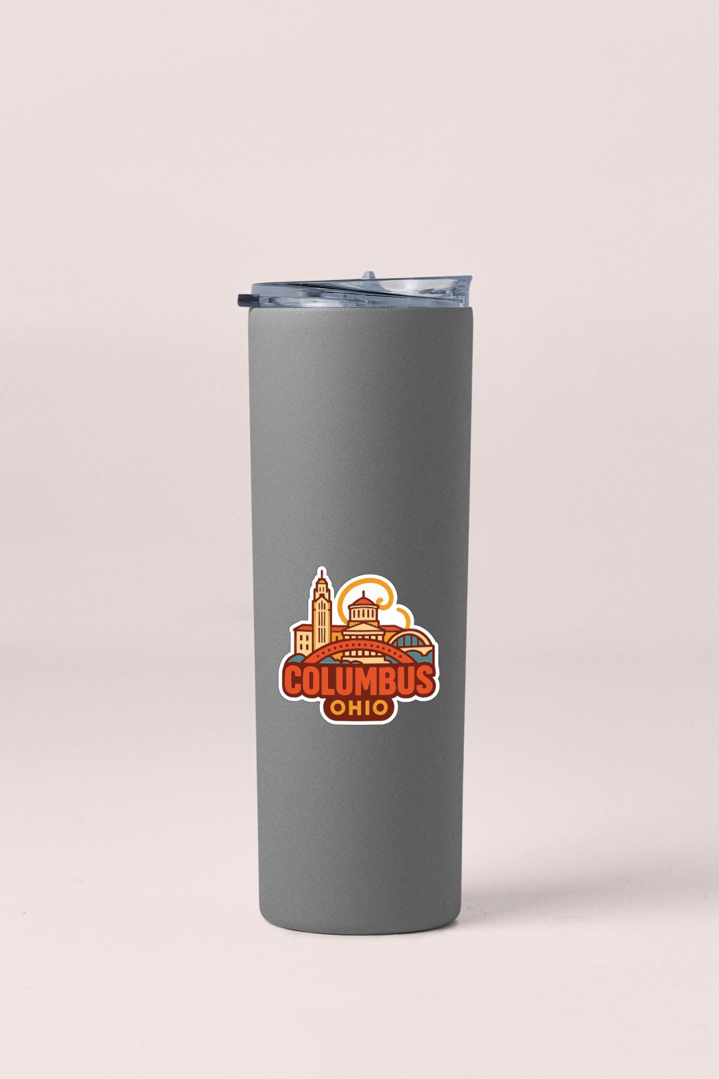A gray insulated tumbler with a lid and a sticker featuring the city of Columbus, Ohio.