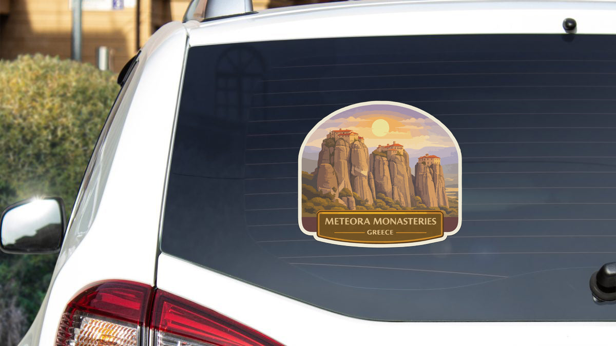 a sticker on the rear window of a car that displays the name "Meteora Monasteries" and the country "Greece".