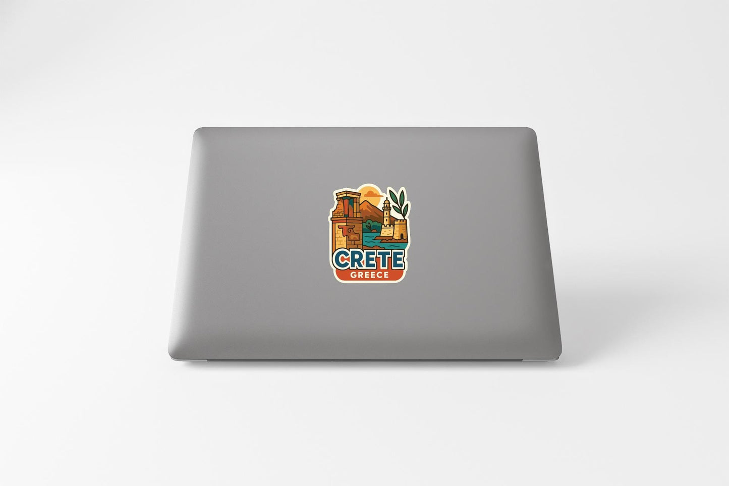 a sticker with a picture of a building and the word "CRETE" on a laptop.