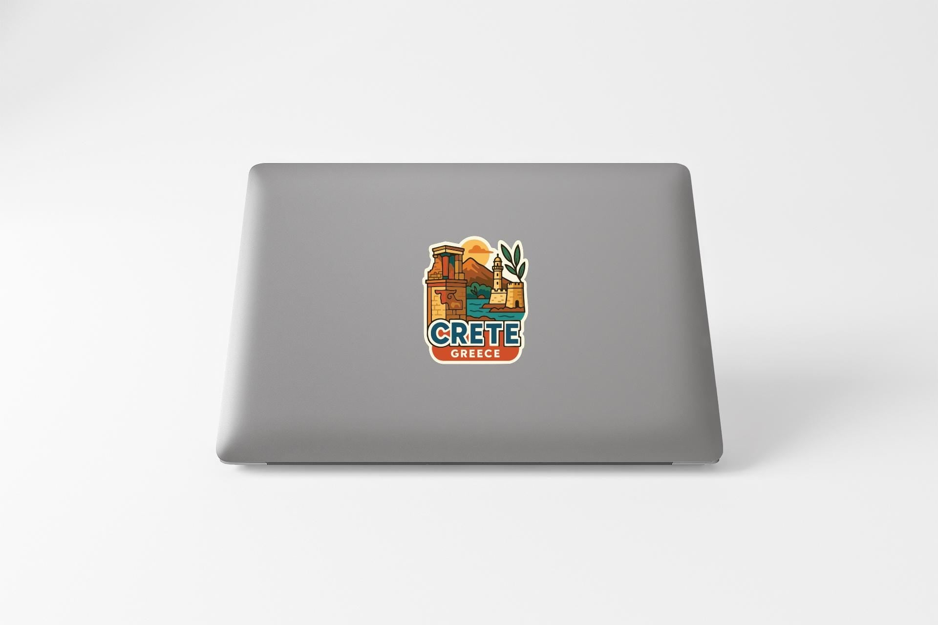 a sticker with a picture of a building and the word "CRETE" on a laptop.
