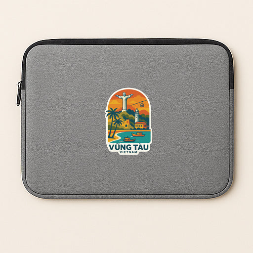 a gray laptop sleeve with a sticker depicting a tropical beach scene and the text "VÜNG TẾU" (Vietnam).