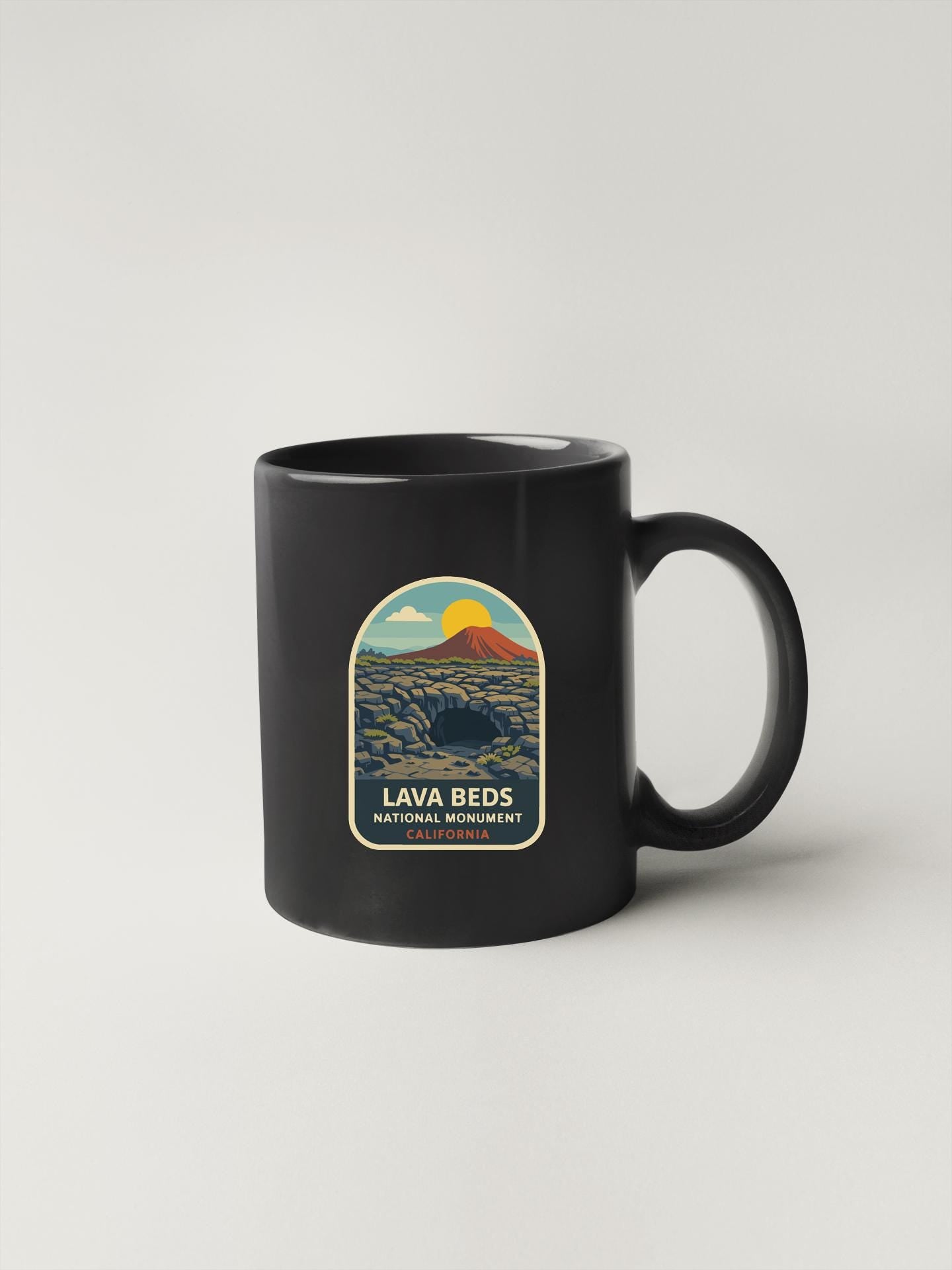 A black coffee mug with a label that says "Lava Beds National Monument California" on it.