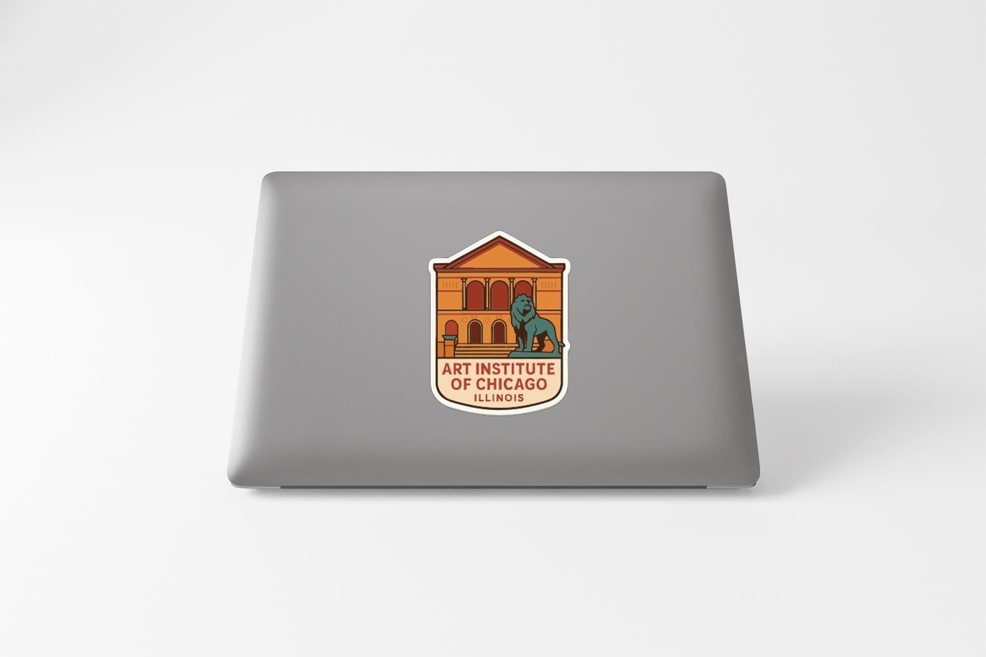 a sticker on the back of a laptop that displays the logo of the Art Institute of Chicago.