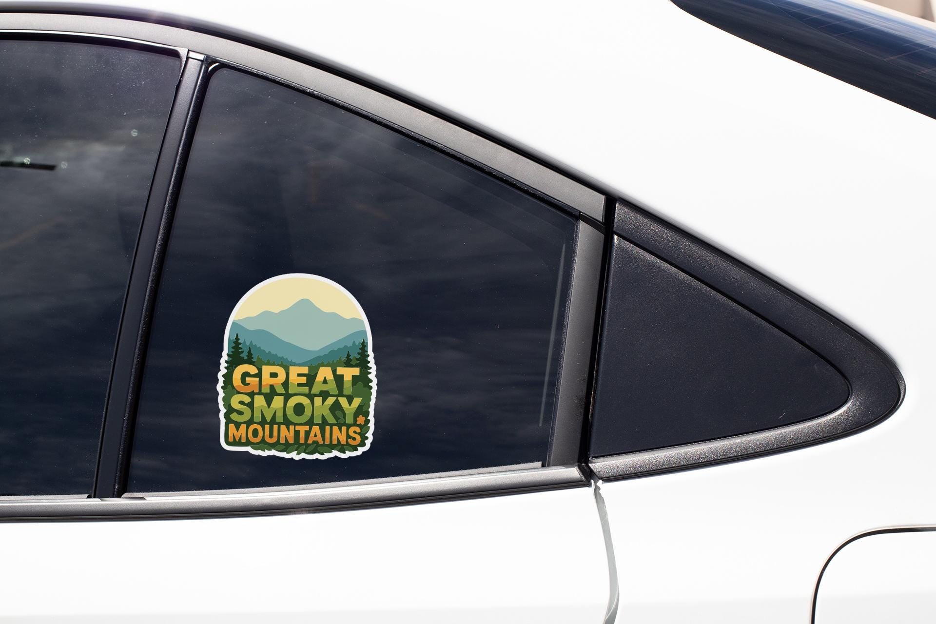 A sticker on the side of a car window that says "GREAT SMOKY MOUNTAINS".
