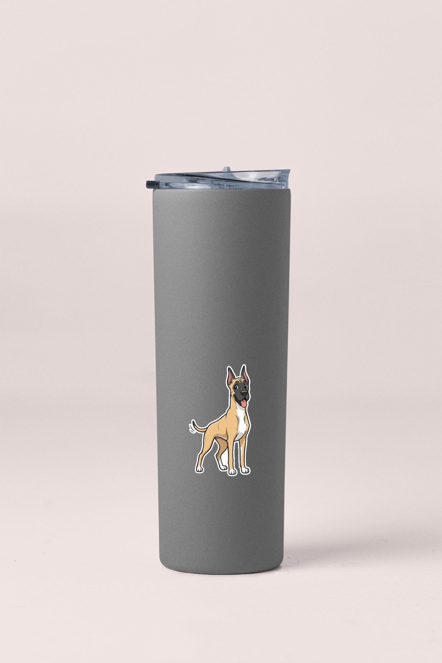 A gray insulated tumbler with a sticker of a cartoon dog on it.