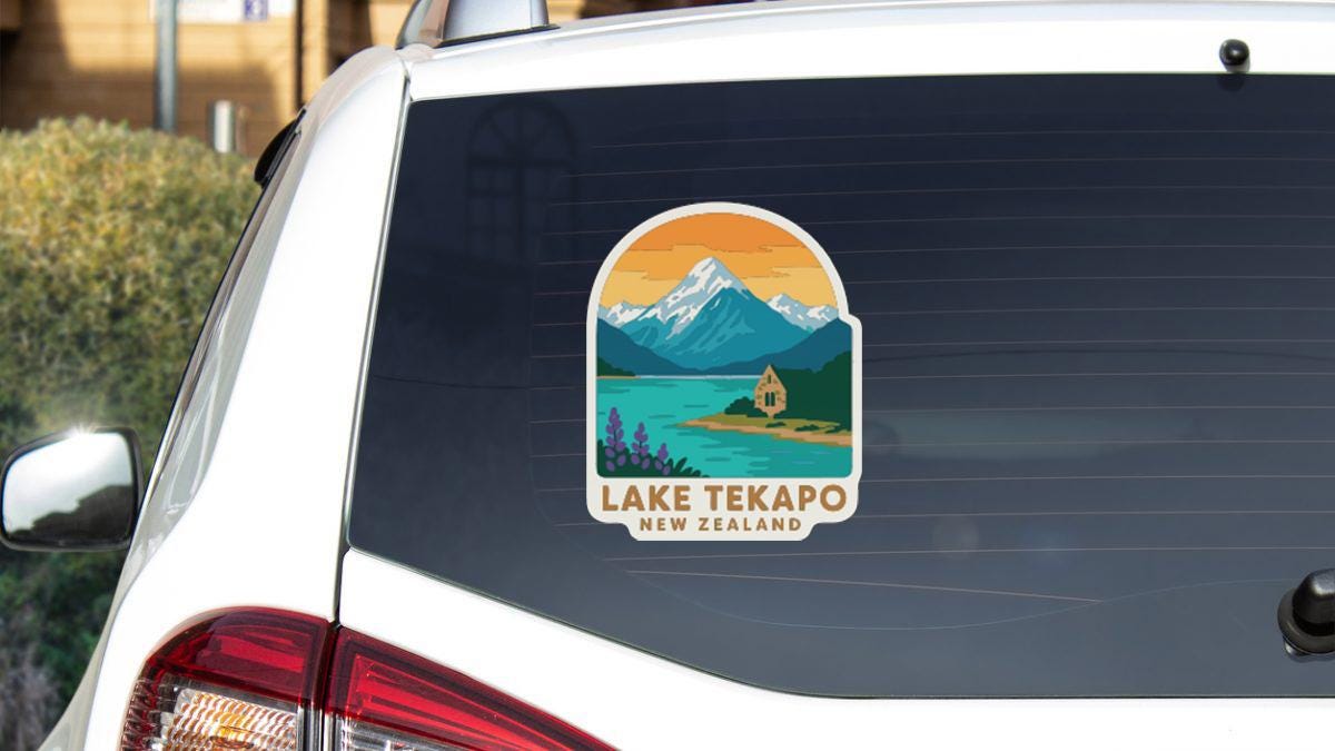 A sticker on the rear window of a car that says "Lake Tekapoo New Zealand".