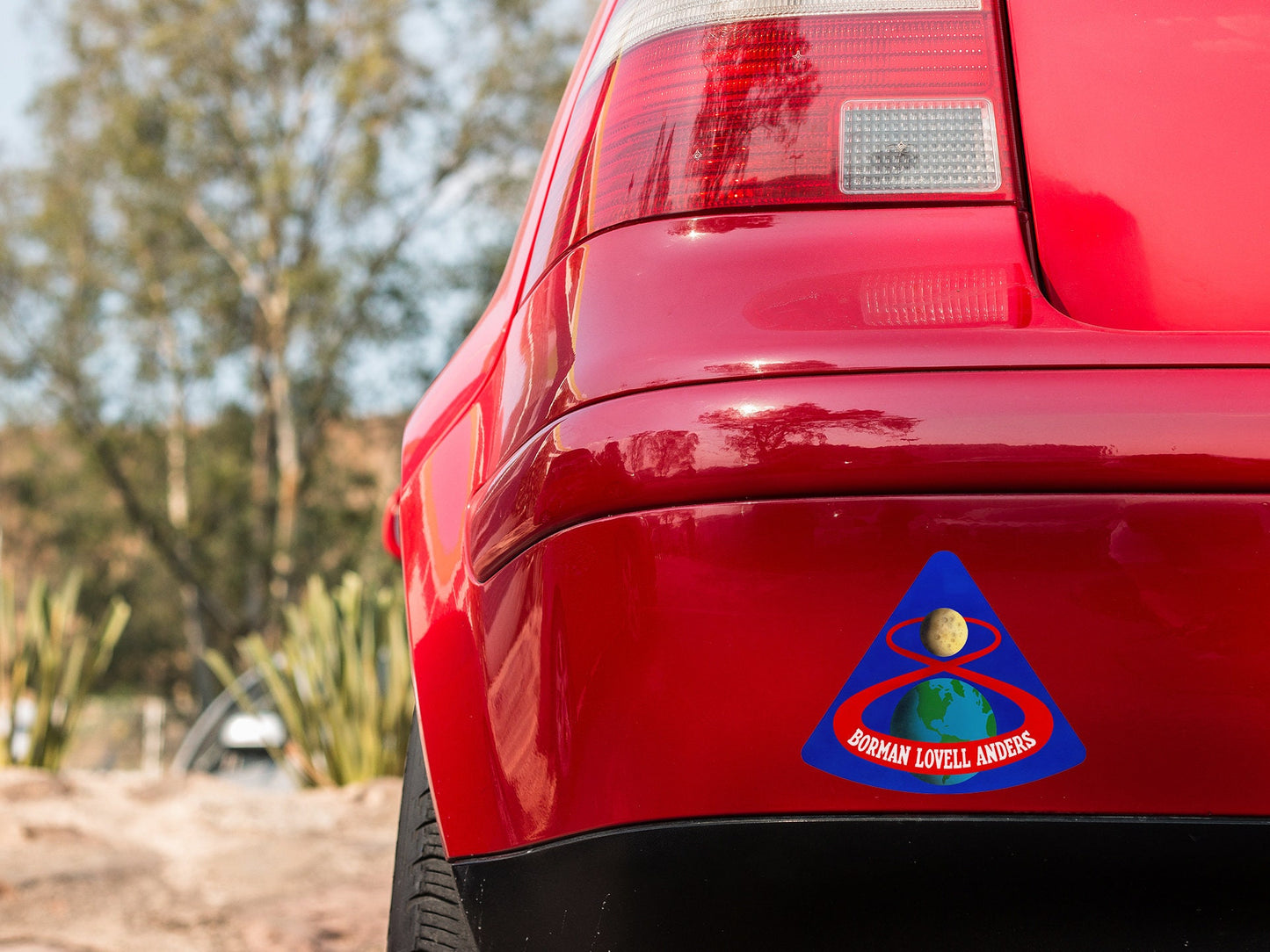 a red car with a blue triangle sticker on it