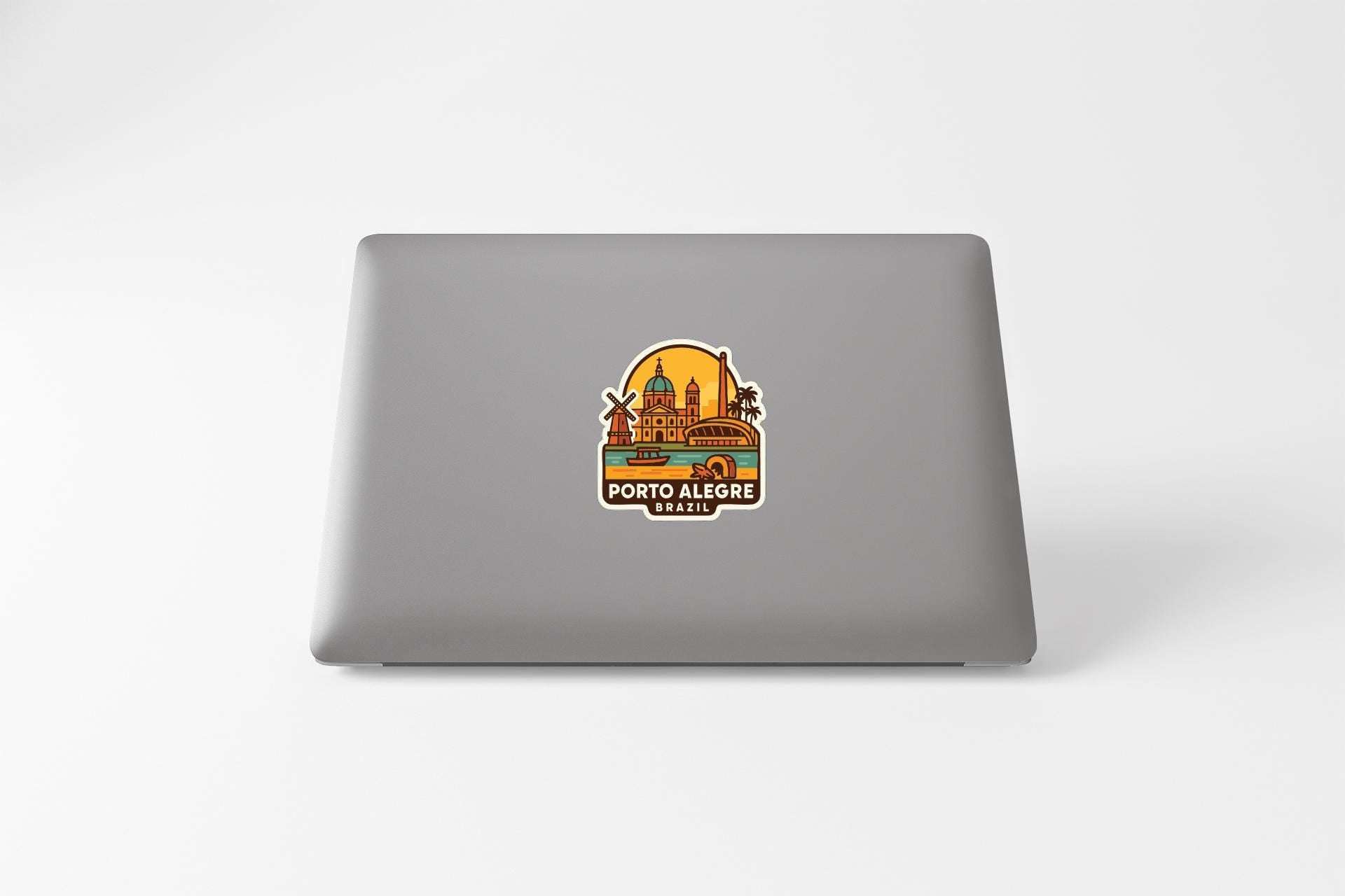 a sticker or decal of a cityscape on the back of a laptop computer.