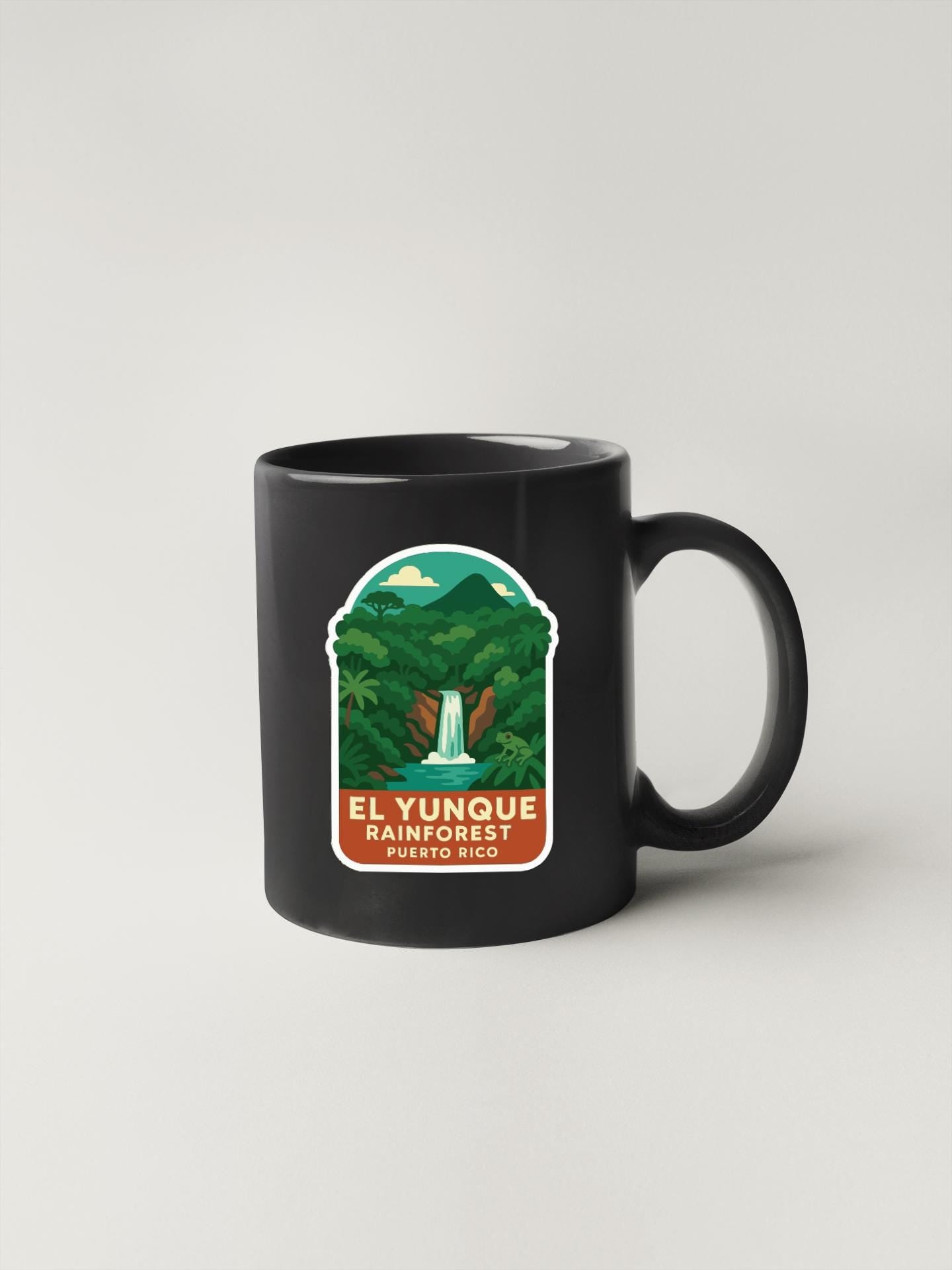 A black coffee mug with a label that says "EL YUNQUE RAINFOREST PUERTO RICO".