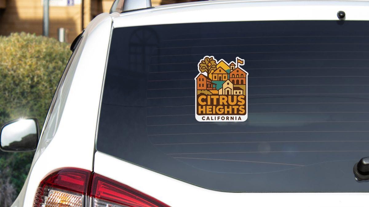 A sticker on the rear window of a white car, displaying the text "CITRUS HEIGHTS, CALIFORNIA".
