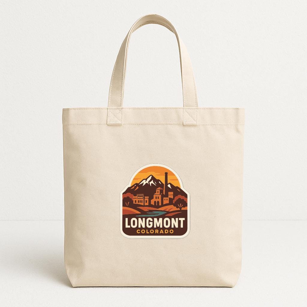 A beige tote bag with a printed logo that says "LONGMONT COLORADO".