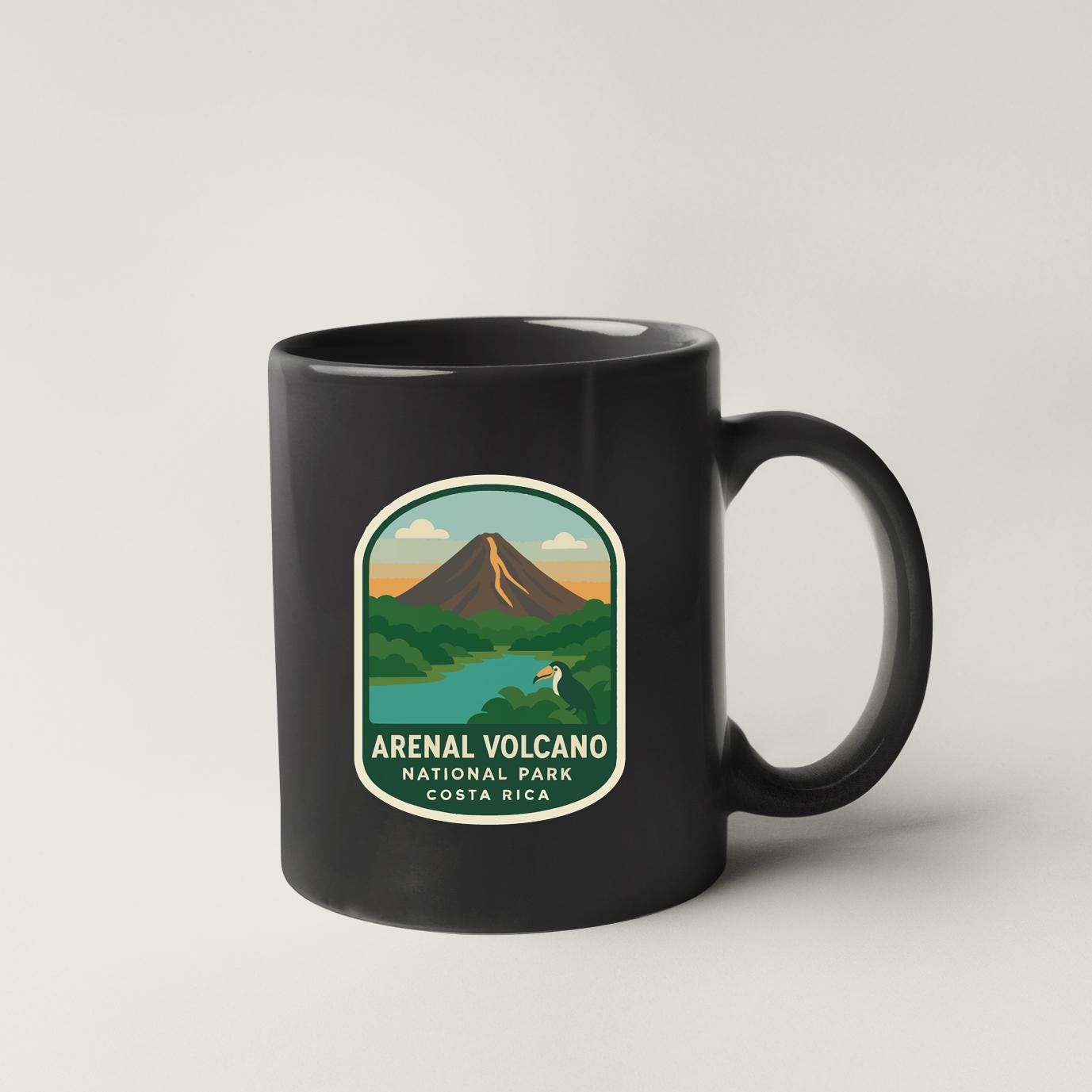 A black coffee mug with a label that says "arenal volcano national park costa rica".