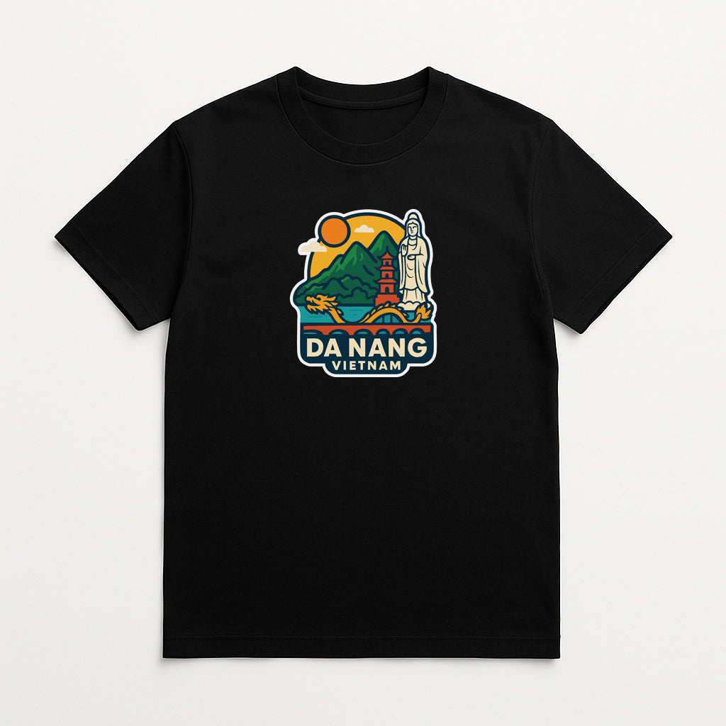 A black t-shirt with a colorful graphic design depicting a scenic landscape with mountains, a temple, and a statue. The text "DA NANG VIETAM" is prominently displayed, indicating the location of the image.