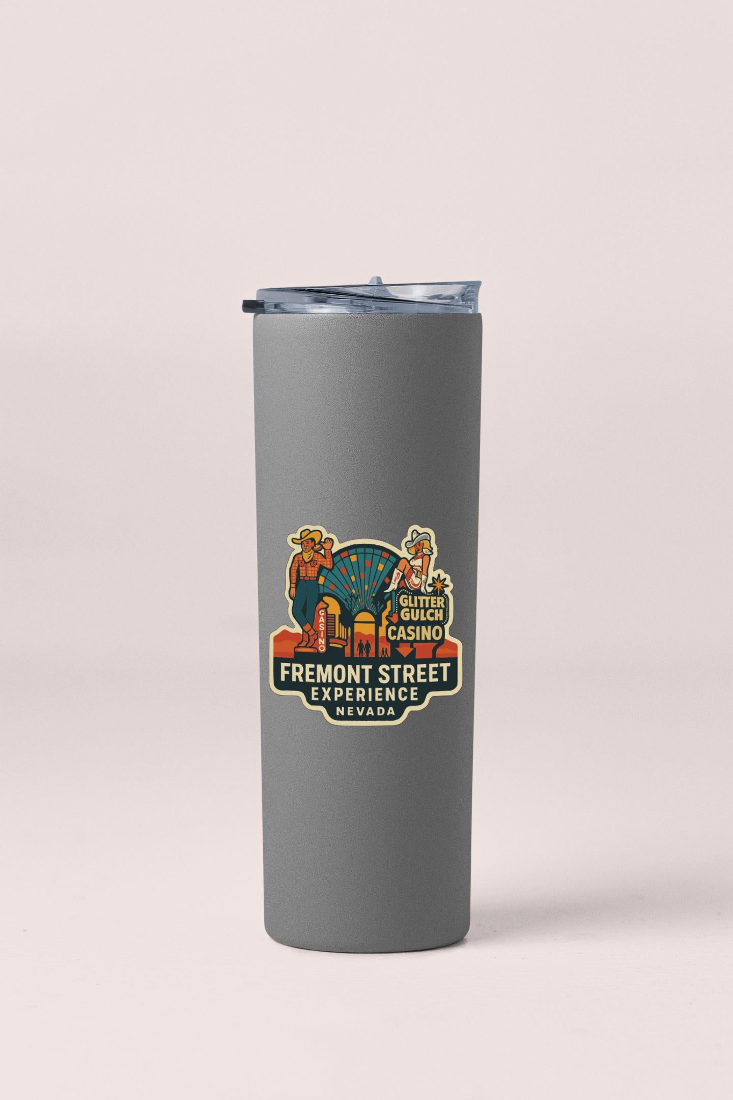 A gray insulated tumbler with a colorful sticker on it, featuring an illustration of a casino and the text "Fremont Street Experience Nevada".