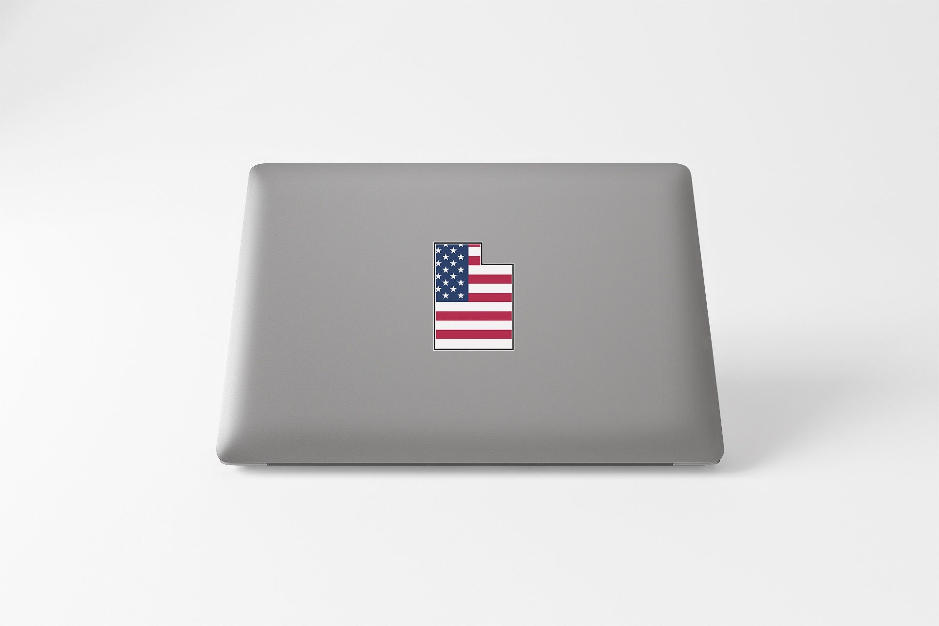a laptop with the american flag sticker on it
