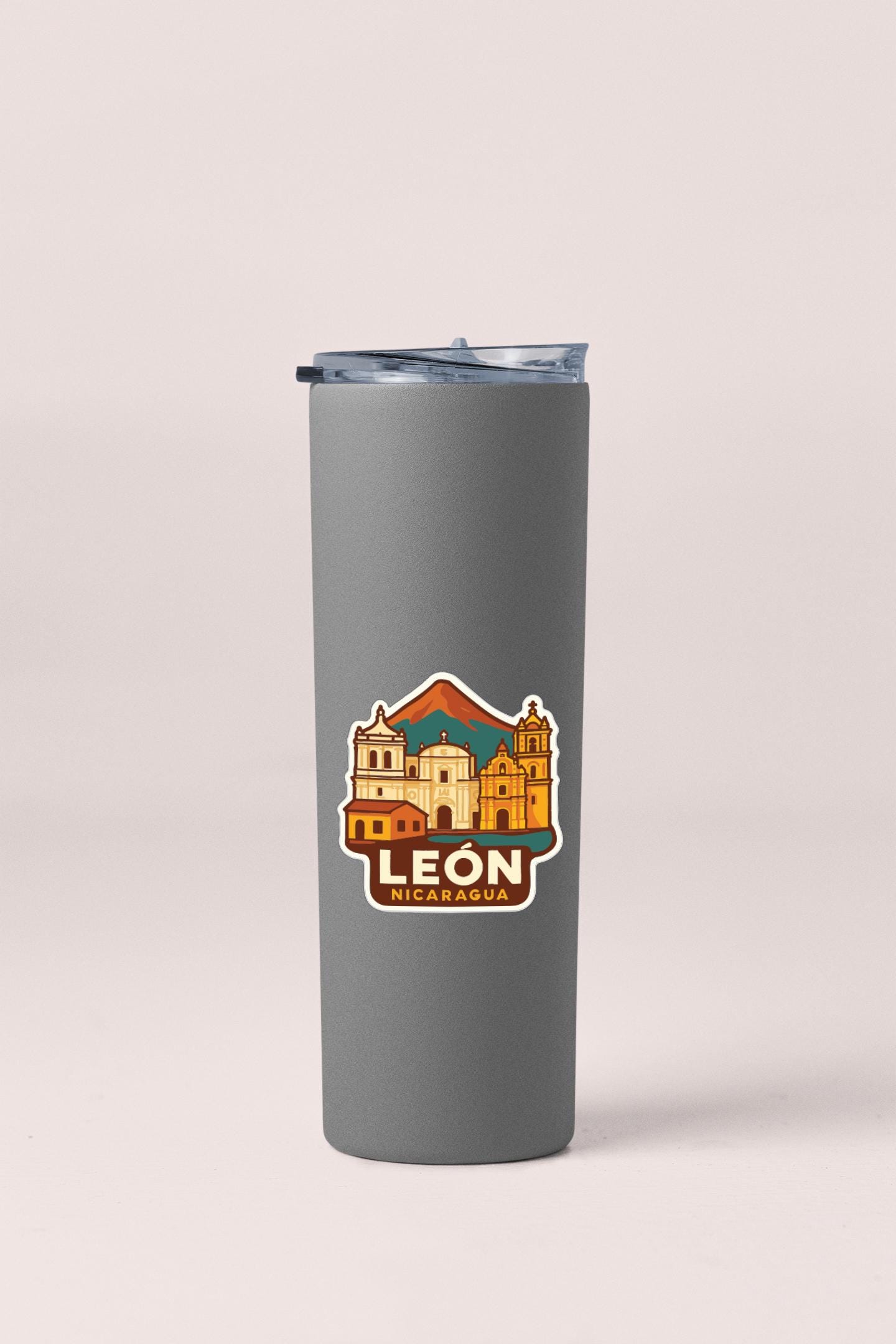 A gray insulated tumbler with a printed sticker depicting the city of Leon, Nicaragua.